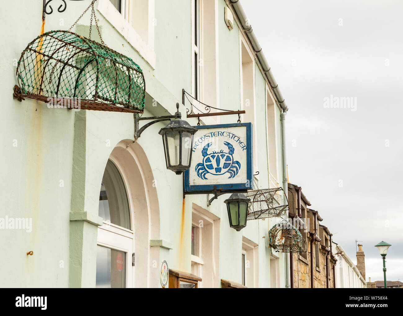 street front of Portmahomack with restaurant sign Stock Photo