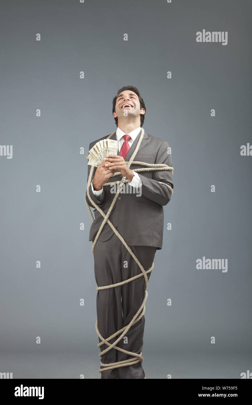 Businessman tied up rope hires stock photography and images Alamy