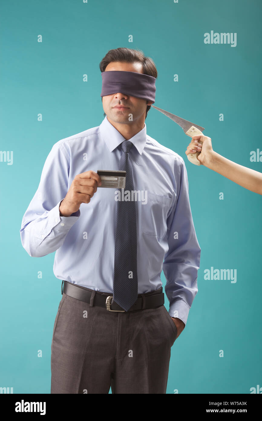 Person hand threatening a blindfolded businessman Stock Photo - Alamy
