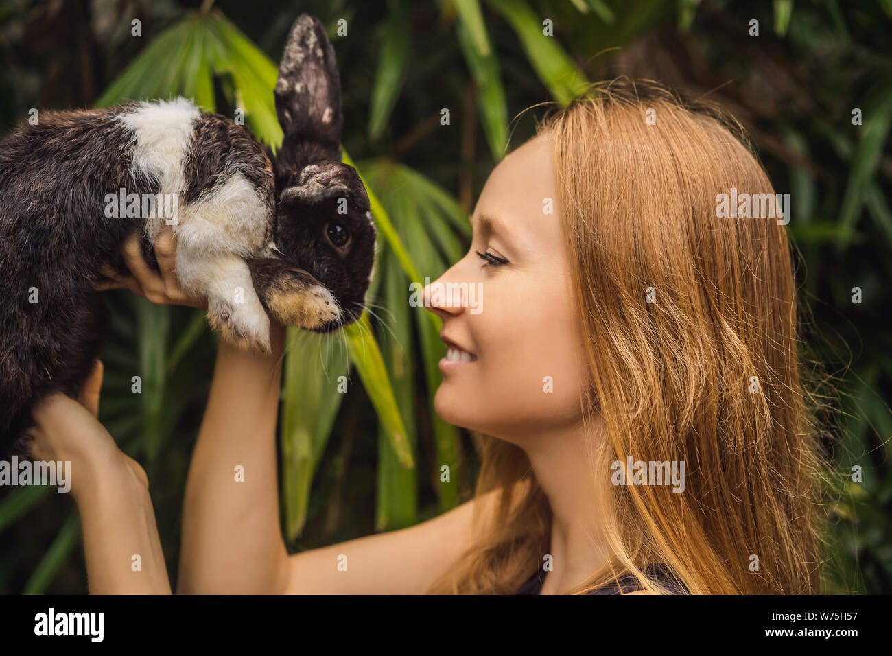 Woman holding a rabbit. Cosmetics test on rabbit animal. Cruelty free ...