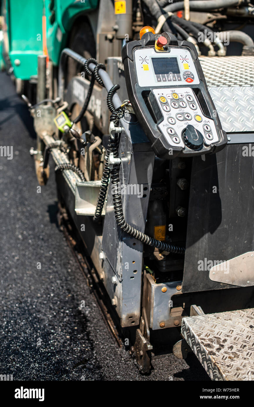 Asphalting machine on the road. Close up Stock Photo - Alamy