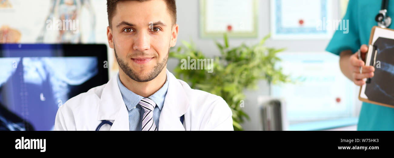 Young handsome doctor posing hi-res stock photography and images - Alamy