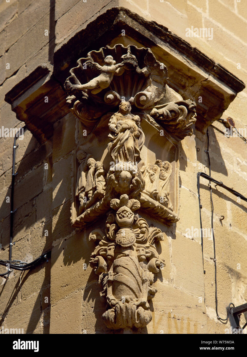 Spain. La Rioja. Cuzcurrita del Rio Tiron. Sculptural detail, religious theme, on the cornerstone of a building. Stock Photo