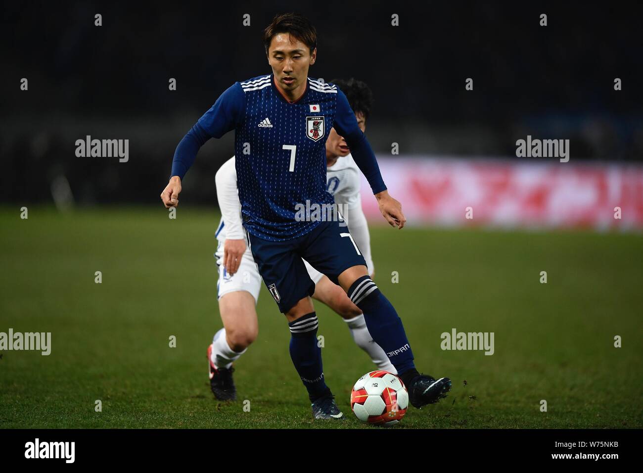 Shu Kurata of Japan challenges a player of South Korea during the men's
