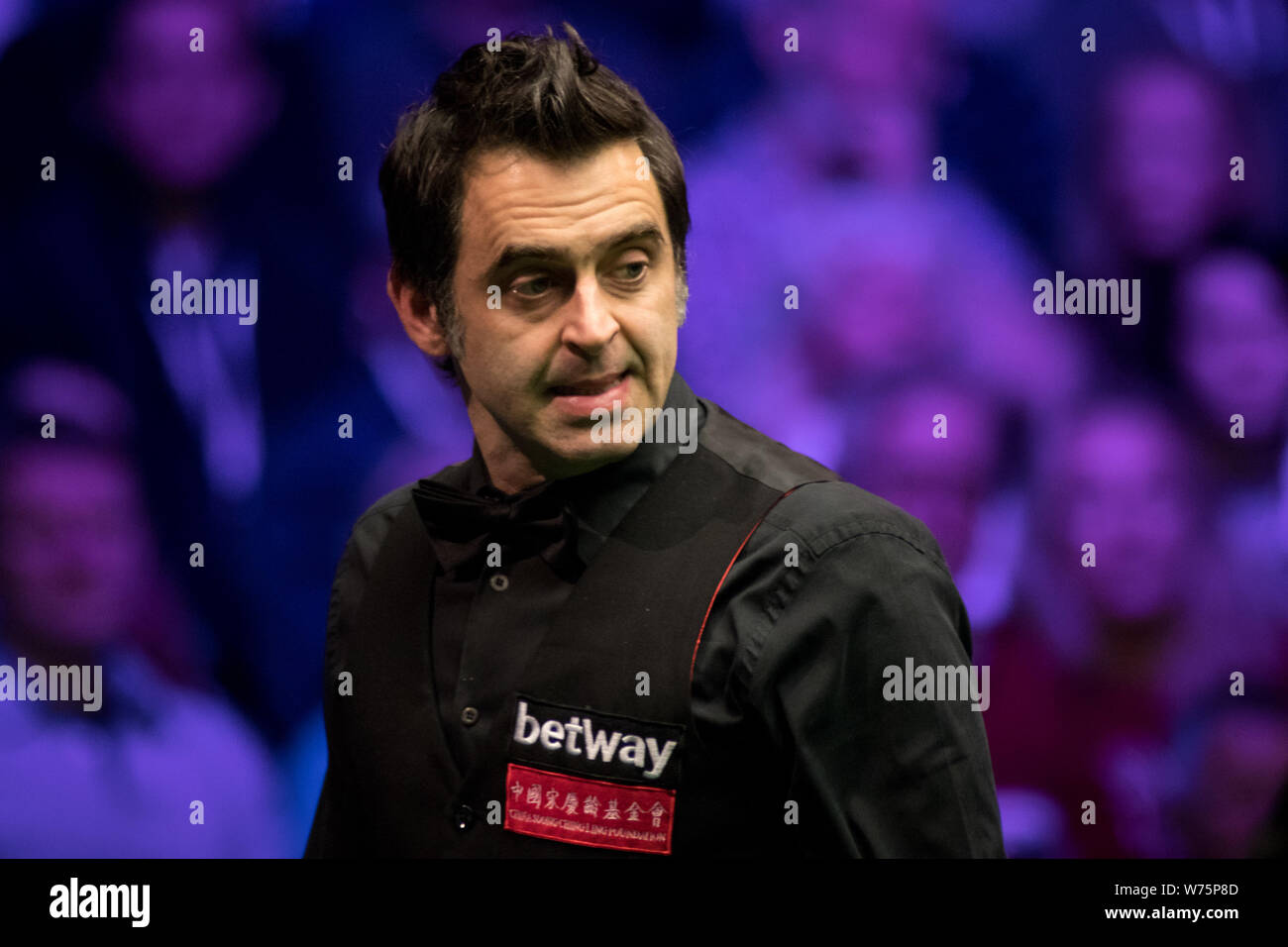 Ronnie O'Sullivan of England considers a shot to Shaun Murphy of England in their final match during the 2017 Betway UK Championship snooker tournamen Stock Photo