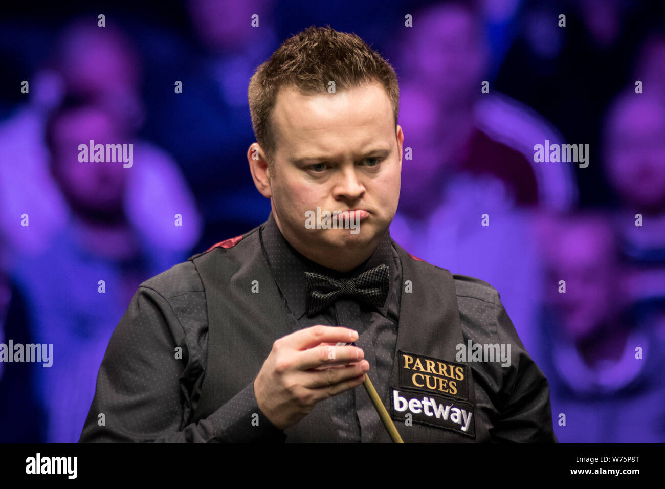 Shaun Murphy of England chalks his cue as he considers a shot to Ronnie O'Sullivan of England in their final match during the 2017 Betway UK Champions Stock Photo
