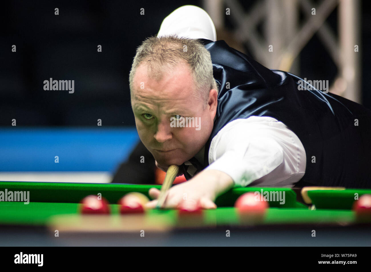 John Higgins of Scotland plays a shot to Jack Lisowski of England in their first round match during the 2017 Dafabet Scottish Open snooker tournament Stock Photo