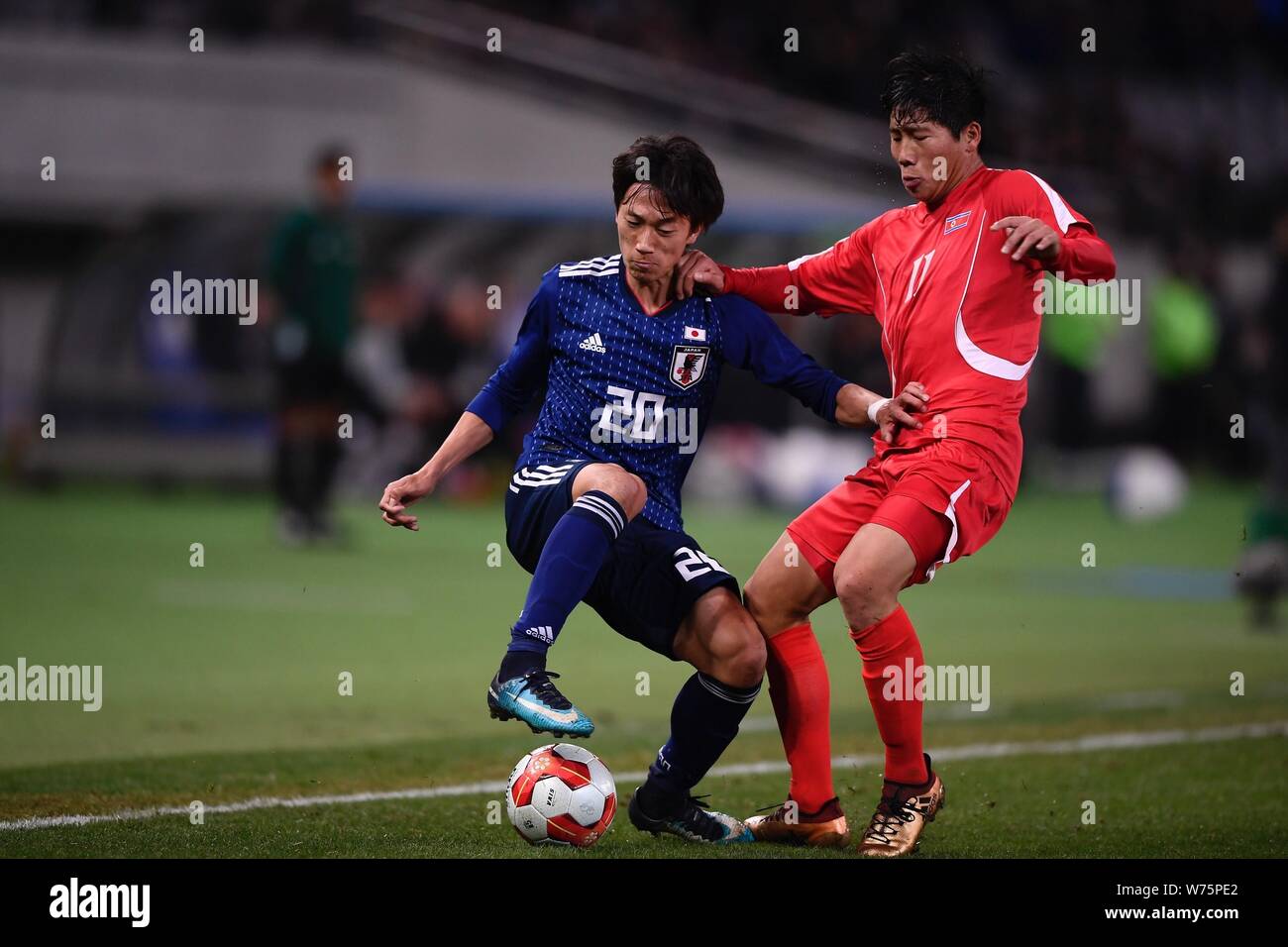 Sei Muroya of Japan, left, challenges Jong Il Gwan of North Korean during the EAFF E-1 Football Championship Final match at Ajinomoto Stadium in Tokyo Stock Photo