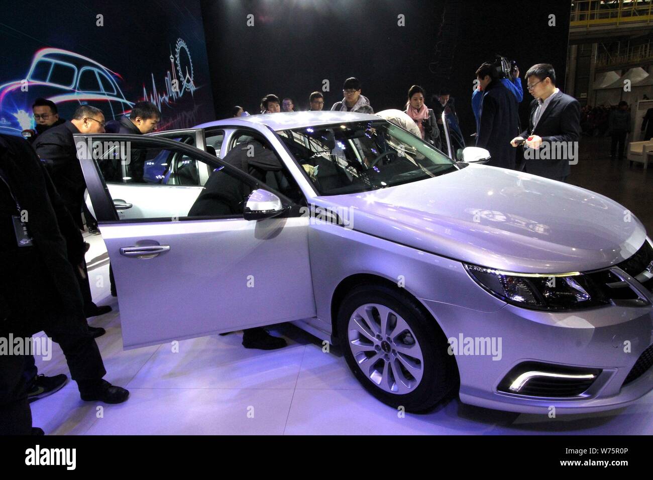 Visitors look at the first NEVS 93 series EV of National Electric