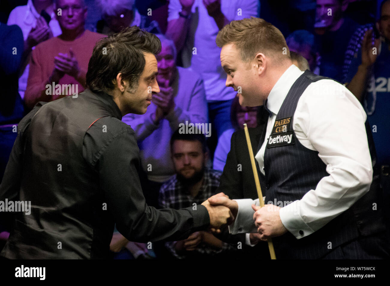 Ronnie O'Sullivan, left, of England shakes hands with Shaun Murphy of England after their final match during the 2017 Betway UK Championship snooker t Stock Photo