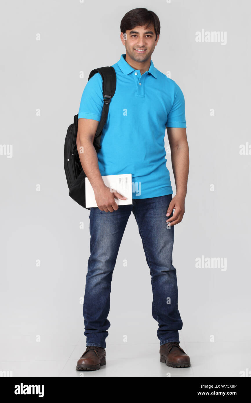 College student holding book smiling Stock Photo - Alamy