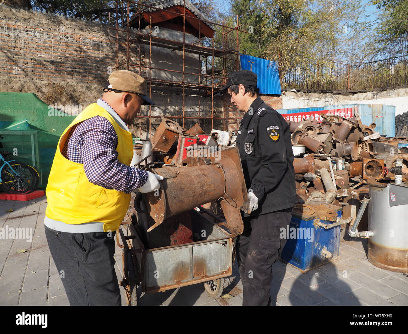 --FILE--Chinese workers help local residents to collect coal stoves for recycling during a campaign to switch coal-fired heating to clean energy at a Stock Photo
