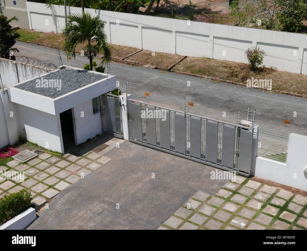 Entrance gate with small building for the security staff of a