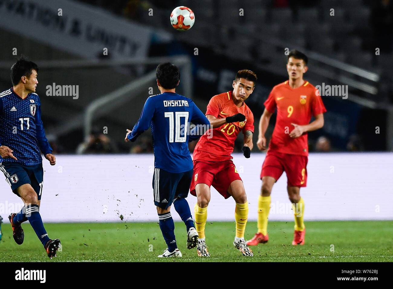 Wei Shihao, right, of China kicks the ball to make a pass against Oshima Ryota of Japan during the EAFF E-1 Football Championship 2017 Final Japan in Stock Photo