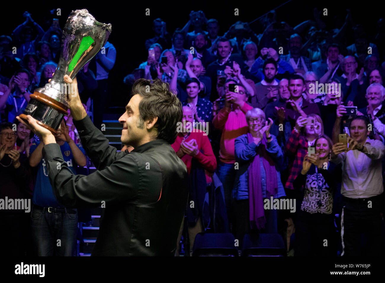 Ronnie O'Sullivan of England poses with his trophy after defeating Shaun Murphy of England in their final match during the 2017 Betway UK Championship Stock Photo