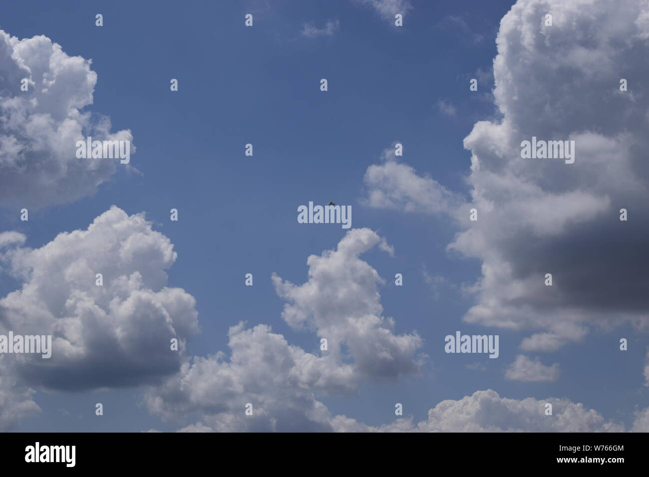 Beautiful white fluffy cloud formations on a deep blue sky Stock Photo