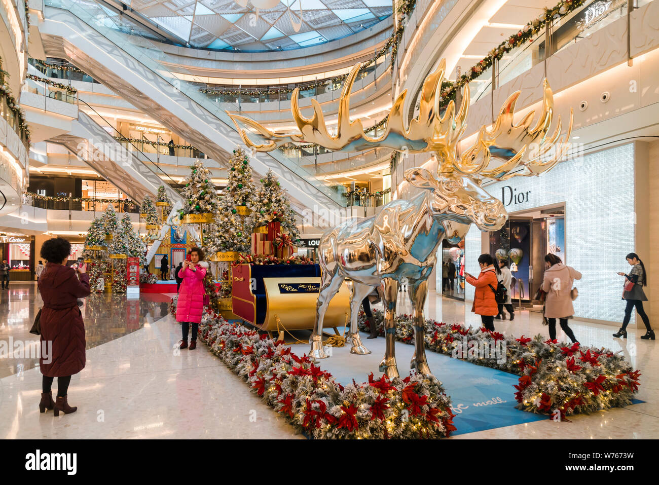 Visitors take photos of a moose manor house on display for the upcoming Christmas at the Shanghai International Finance Centre (IFC) in Shanghai, Chin Stock Photo