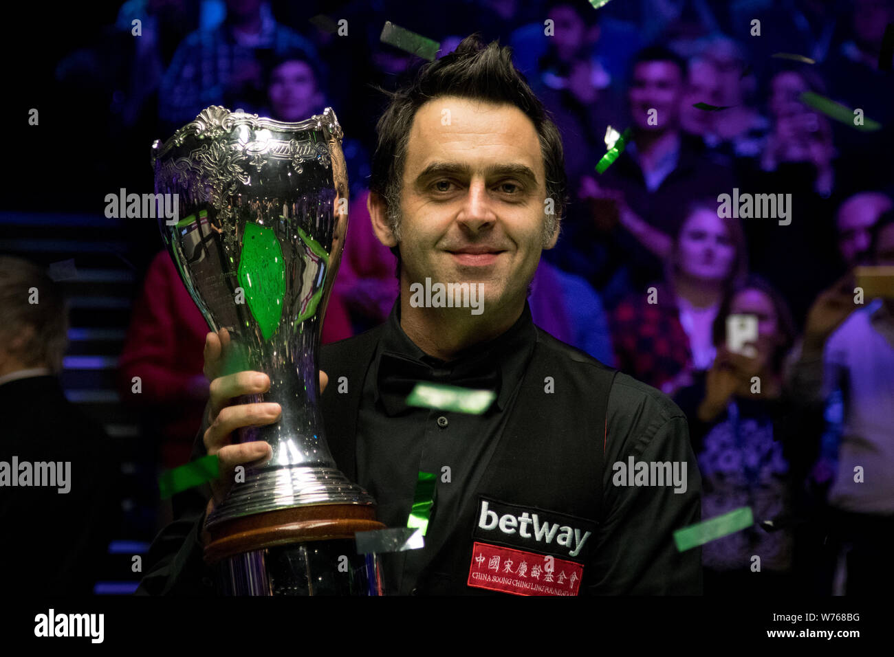 Ronnie O'Sullivan of England poses with his trophy after defeating Shaun Murphy of England in their final match during the 2017 Betway UK Championship Stock Photo