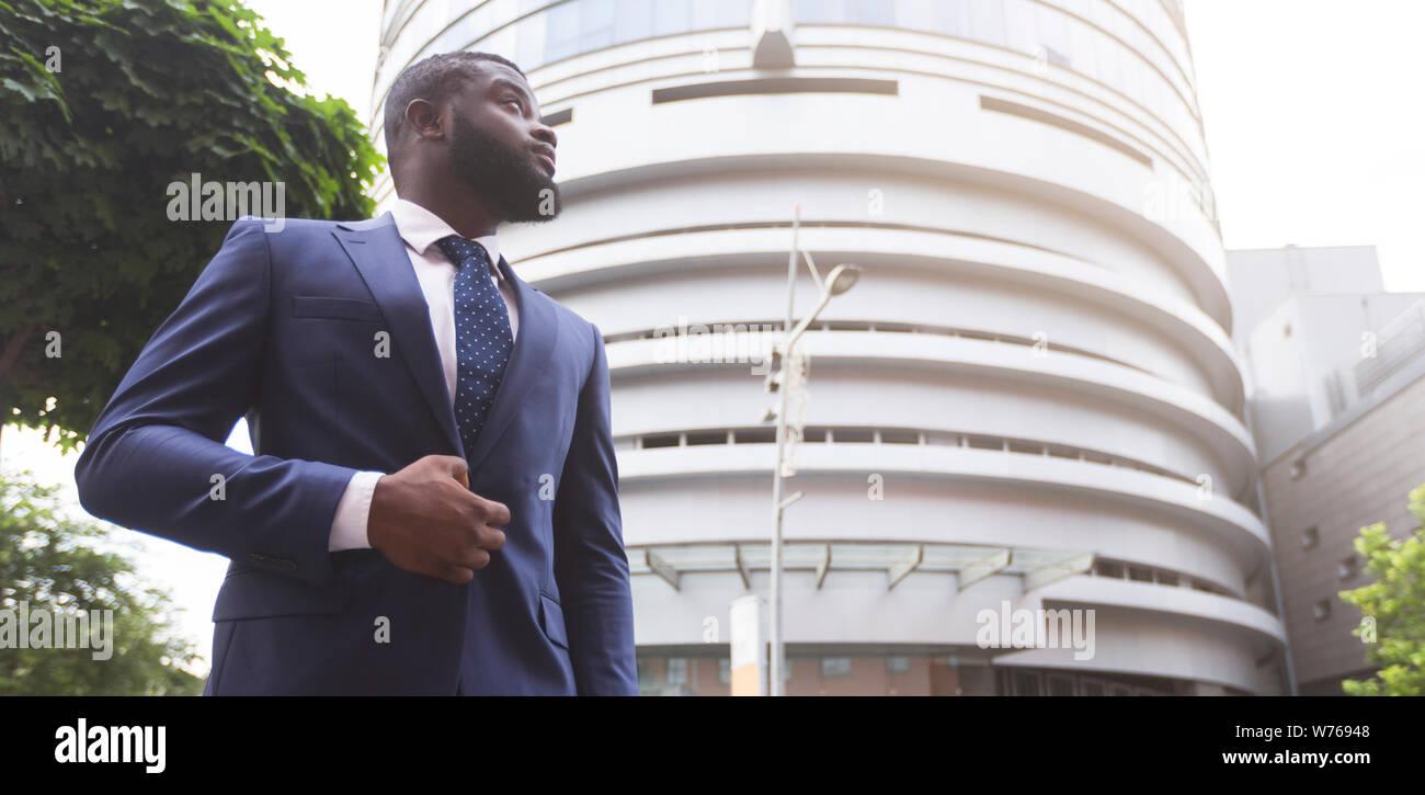 Confident black businessman against modern office center background Stock Photo