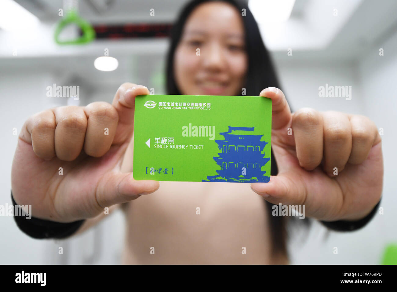 A passenger shows her single journey ticket in a subway train at a subway station on the Metro Line 1 in Guiyang city, southwest China's Guizhou provi Stock Photo