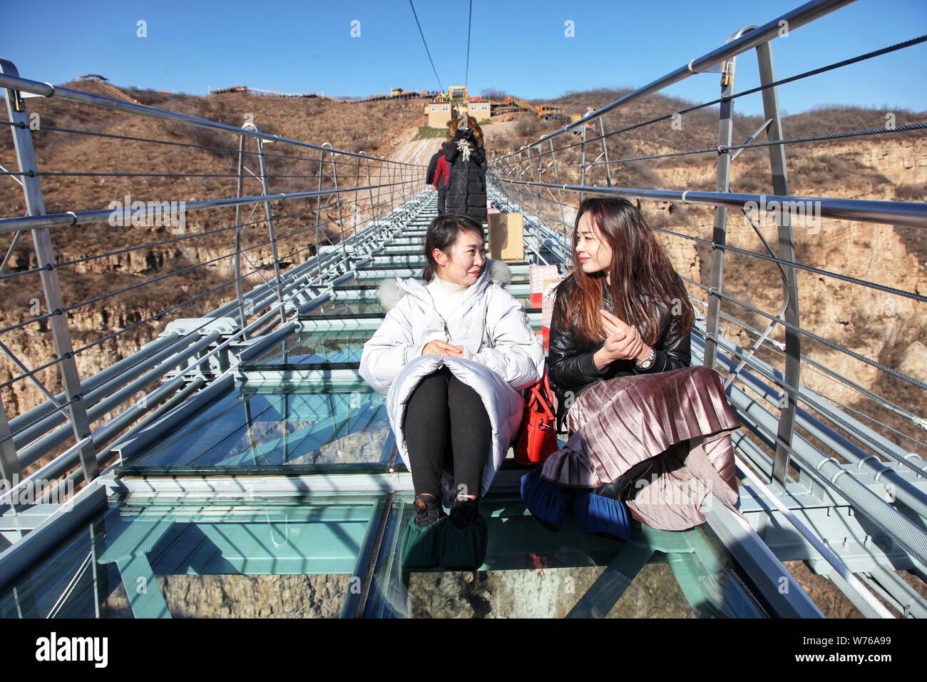 Tourists Pose For Photos On The World s Longest Glass Suspension Bridge tourists-pose-for-photos-on-the-world-s-longest-glass-suspension-bridge