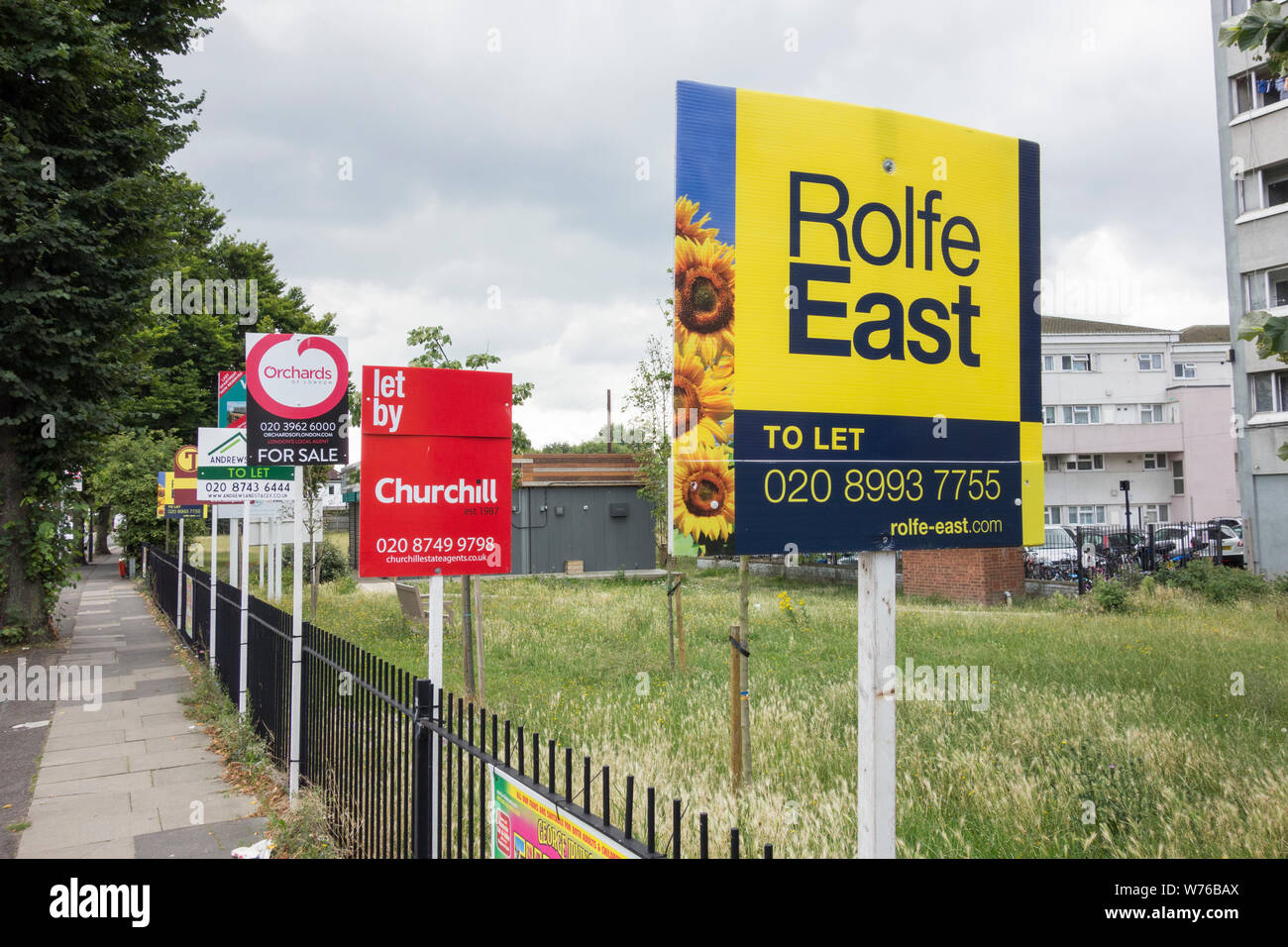 Estate agents For Sale and To Let boards on Old Oak Road, Acton, west London, UK Stock Photo
