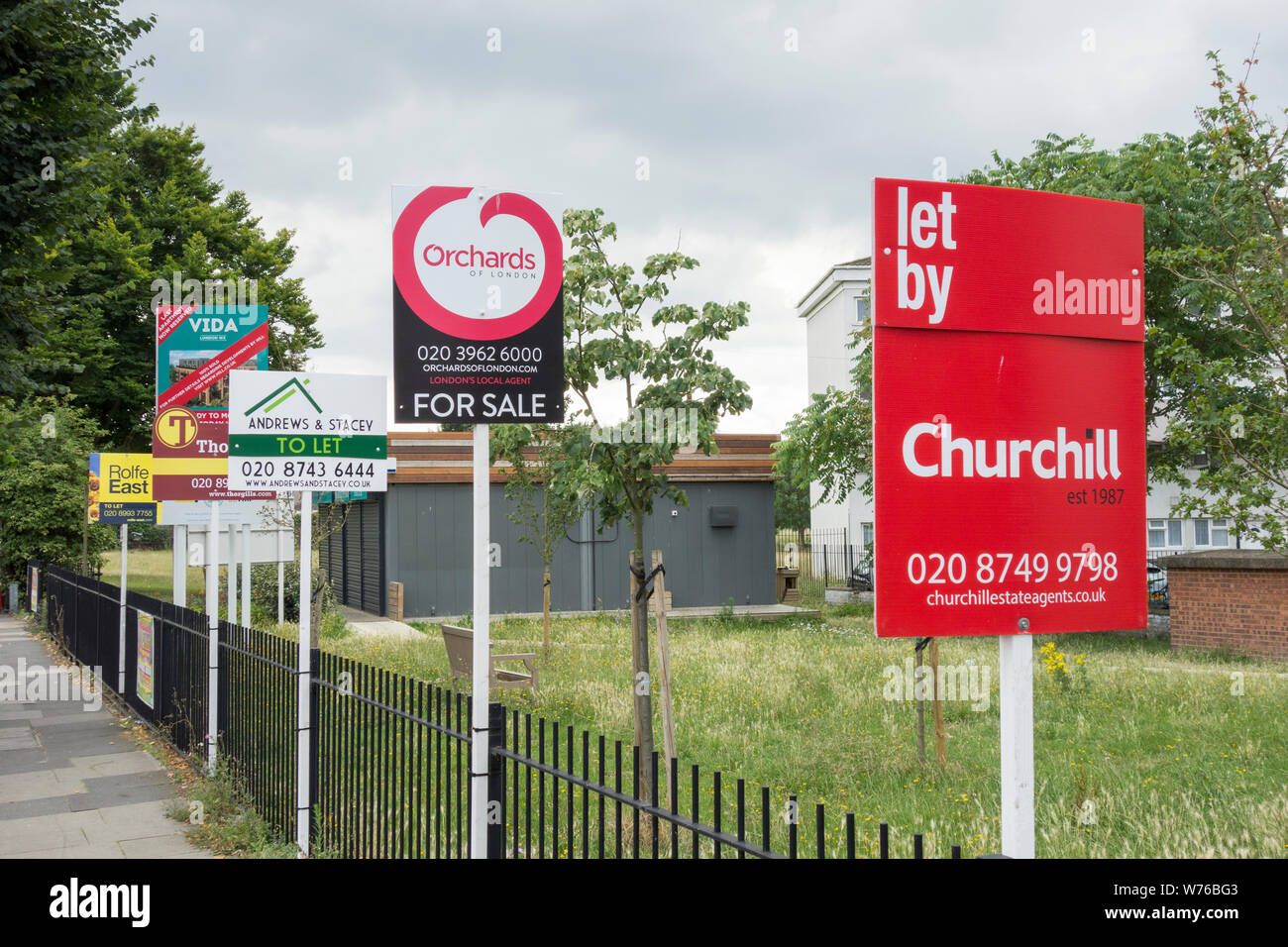 Estate agents For Sale and To Let boards on Old Oak Road, Acton, west London, UK Stock Photo