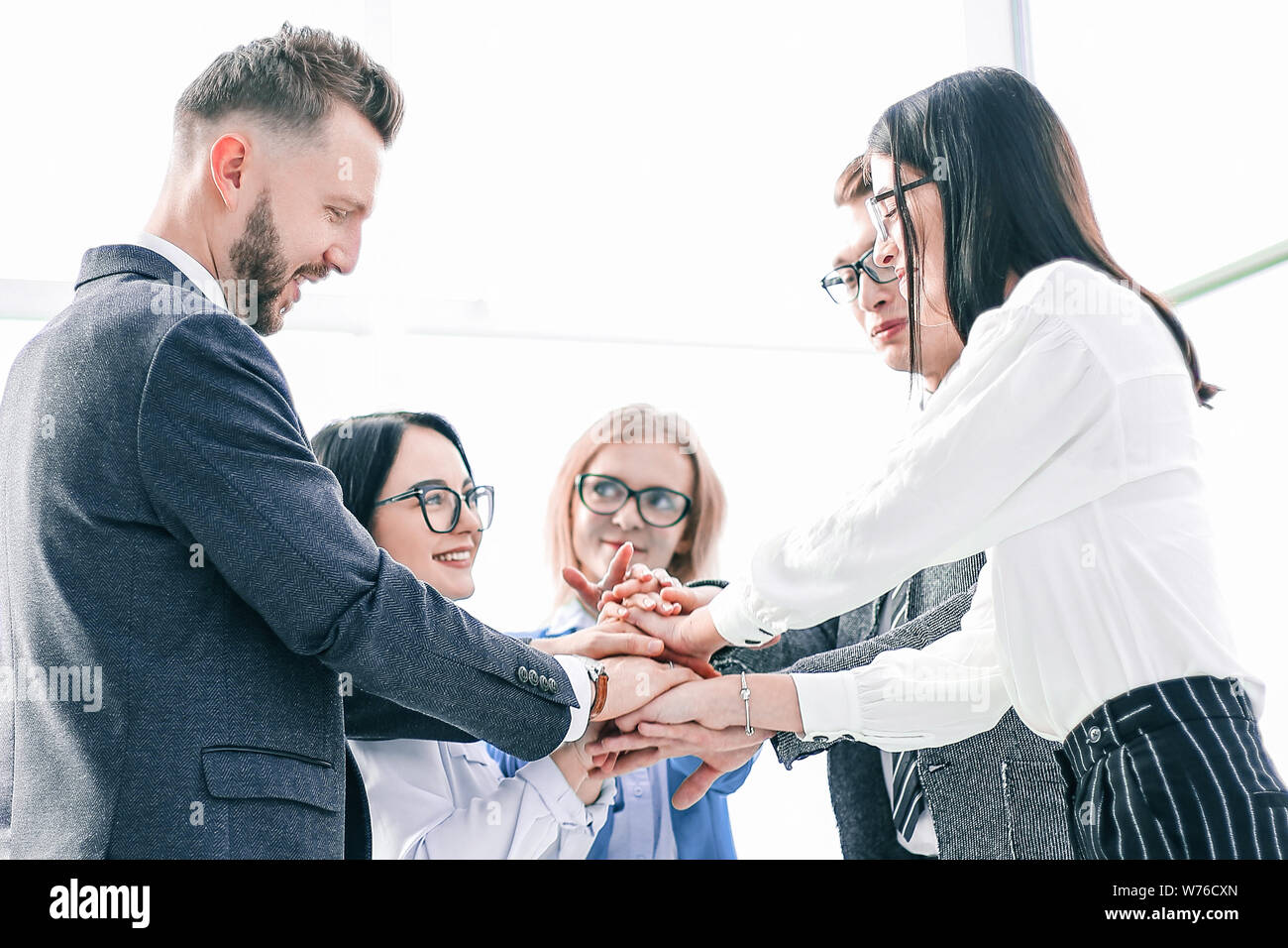 business team showing their unity while standing in the office Stock Photo