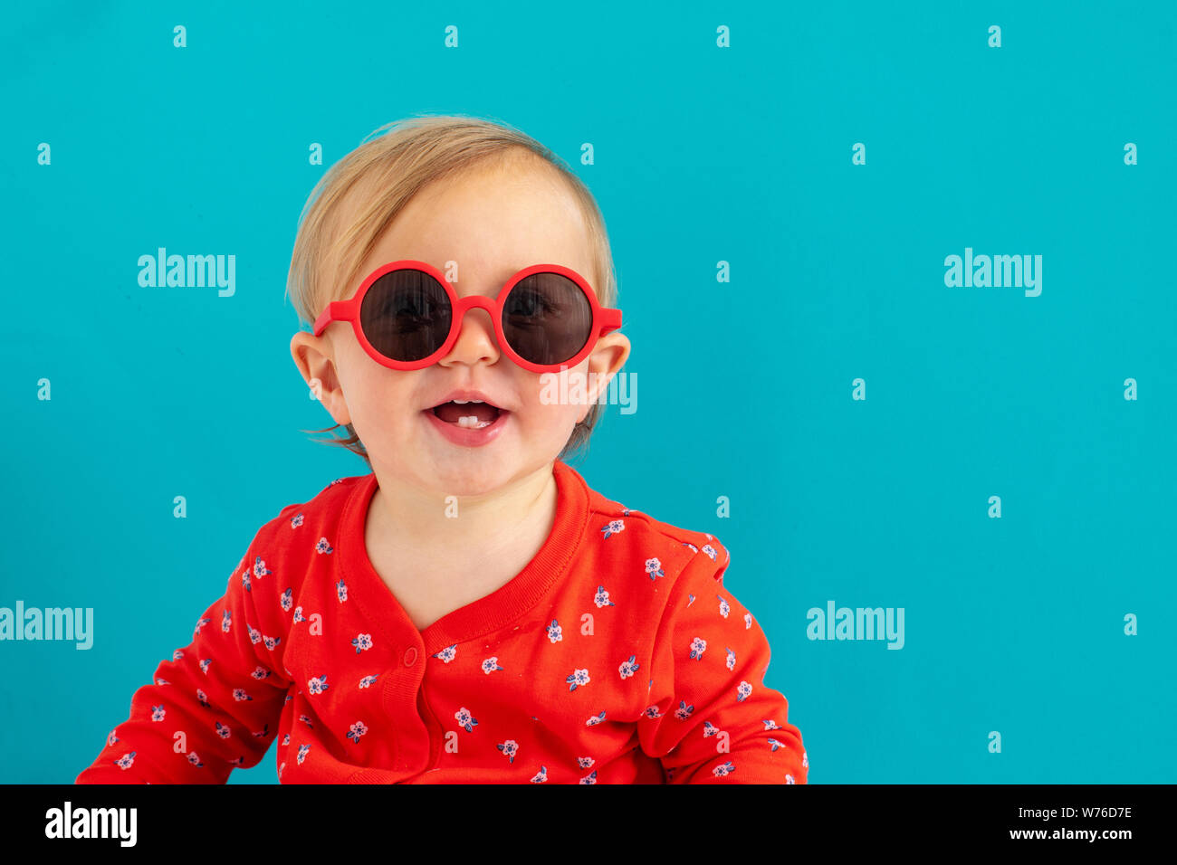 Cute baby in red sunglasses smile Stock Photo