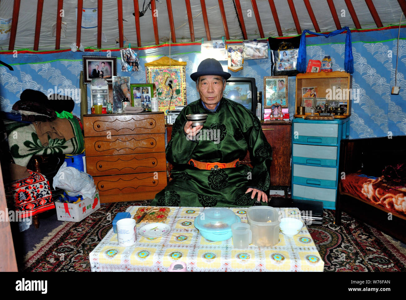 A Mongolian nomad poses in traditional clothes in his ger Stock Photo ...