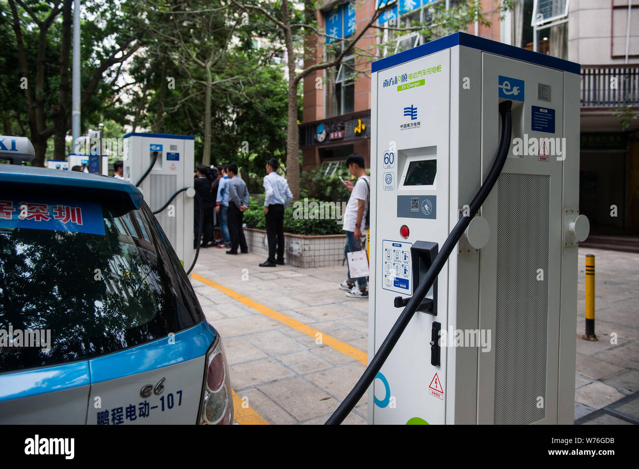An electric taxi is being recharged at China's first roadside parking with electric vehicle (EV) charging piles in Shenzhen city, south China's Guangd Stock Photo