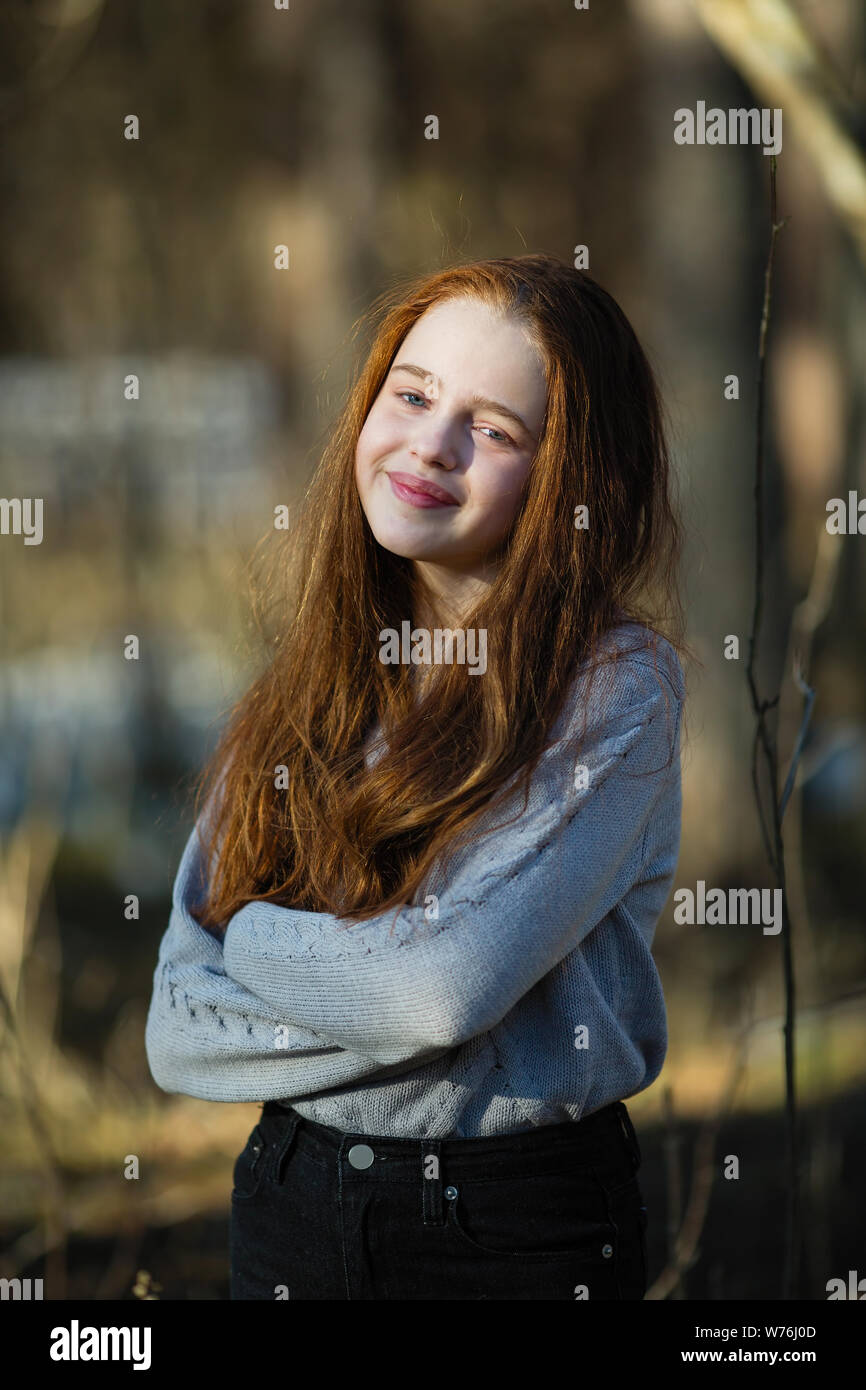 Portrait of a cute girl with long red hair outdoors Stock Photo - Alamy