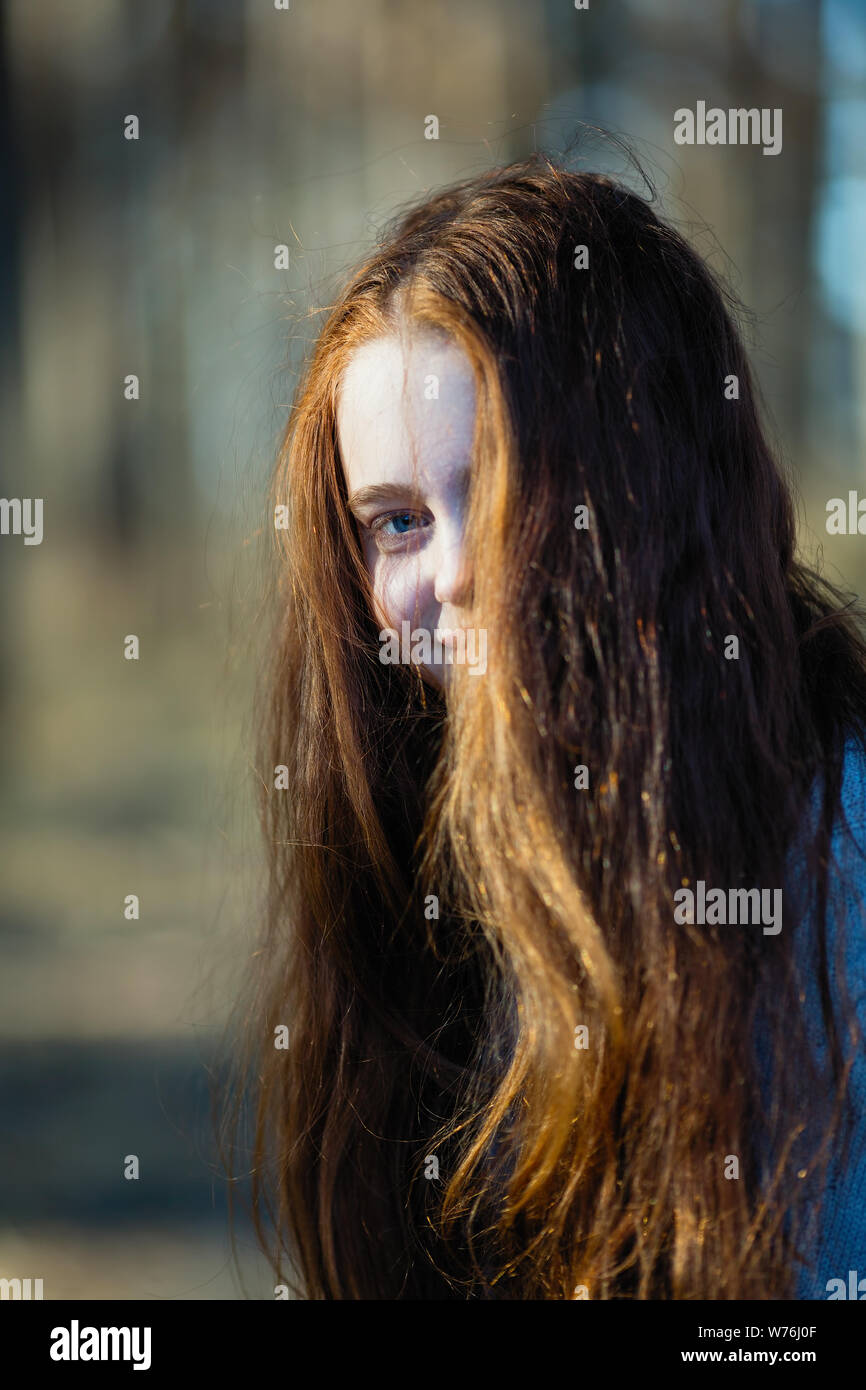 Close-up portrait of a girl with long red hair outdoors Stock Photo - Alamy