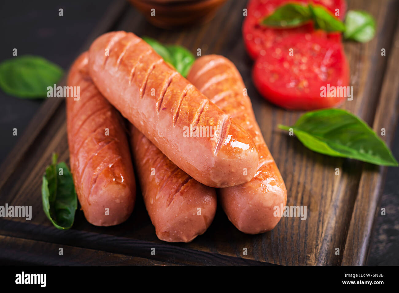 Grilled sausage with tomatoes, basil salad and red onions. BBQ menu
