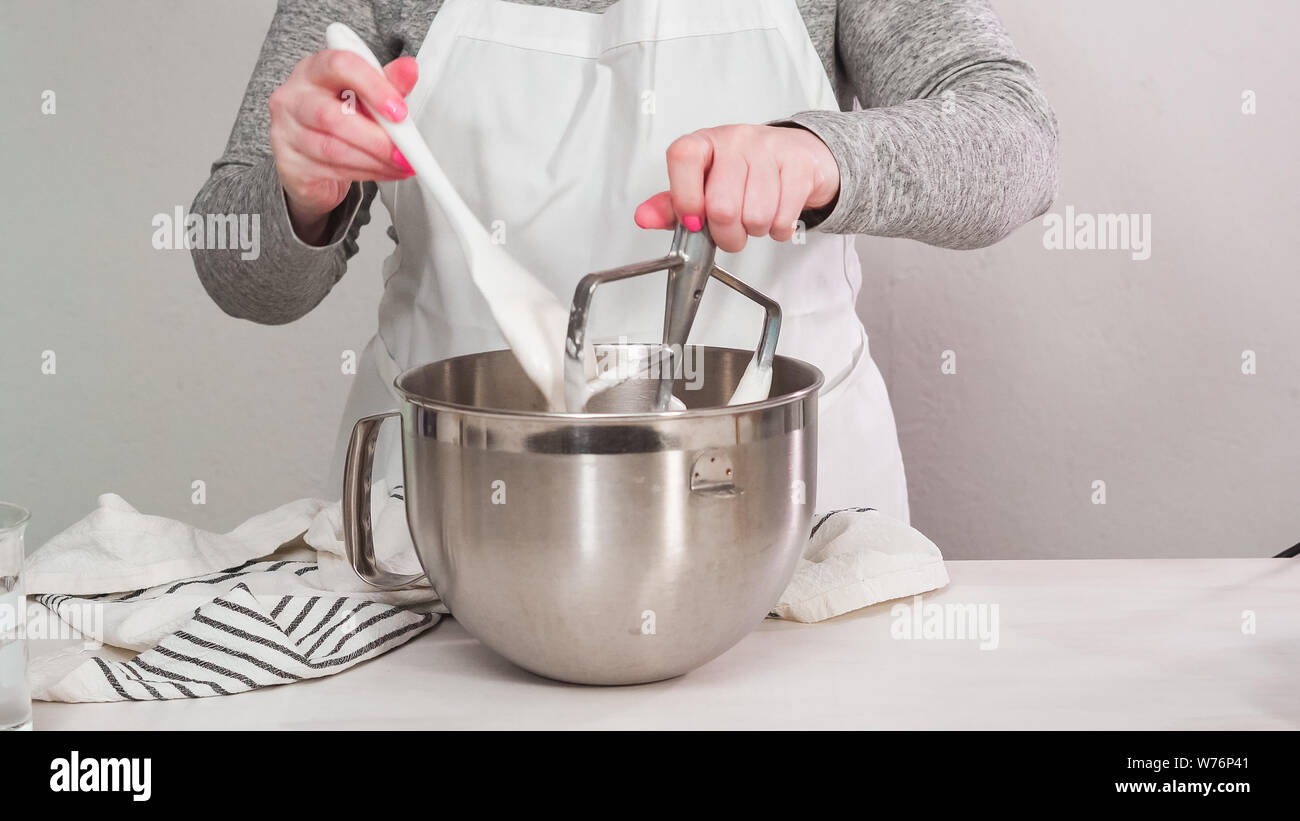 Step by step. Flat lay. Mixing royal icing in electric kitchen mixer