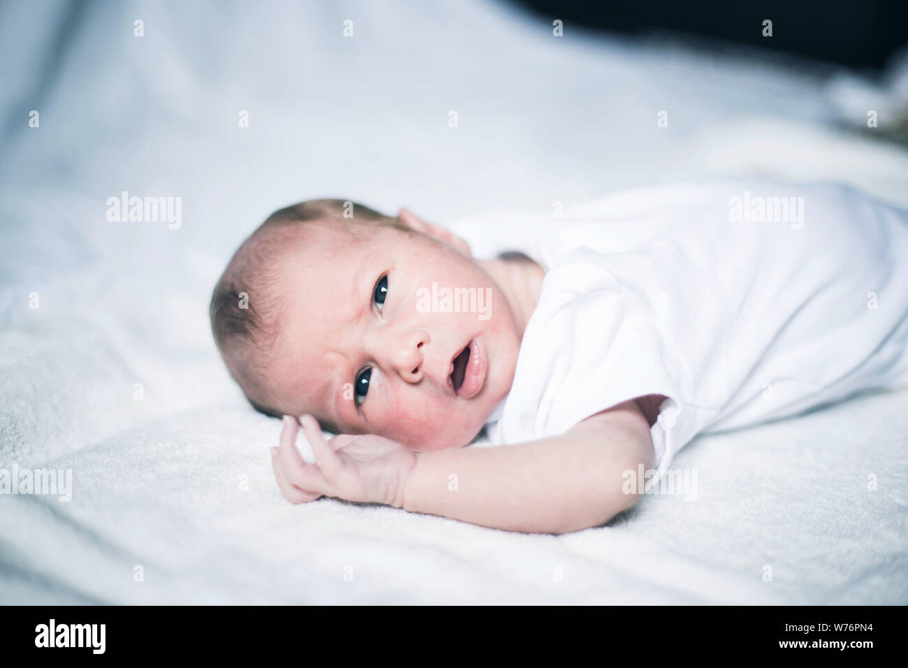 newborn baby waking up in the crib Stock Photo Alamy