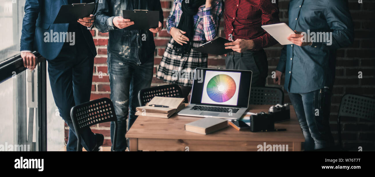 open laptop computer with a color palette in workplace designer Stock