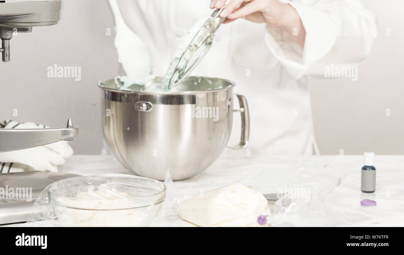 Mixing ingredients in standing kitchen mixer to make buttercream