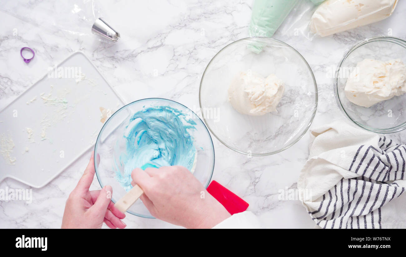 Mixing food coloring with buttercream frosting Stock Photo Alamy