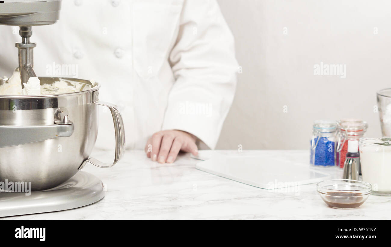 Mixing ingredients in standing kitchen mixer to make buttercream