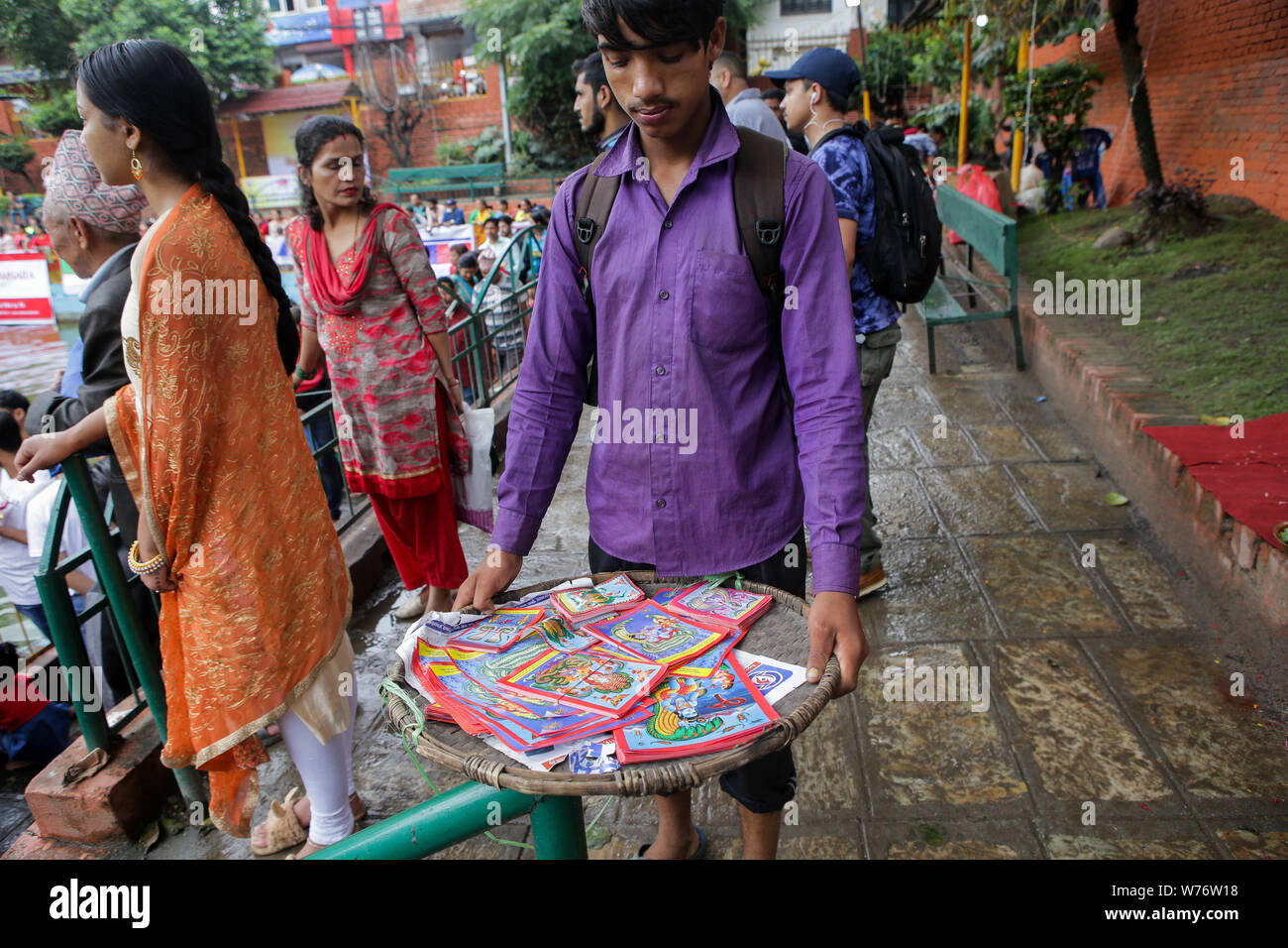 A vendor sells images of snake god during a Festival.Nag-Panchami is a festival to worship snakes or serpents, it’s observed by Hindus all over the world. The festival is observed during the monsoon with prayers and tributes to snakes. Stock Photo