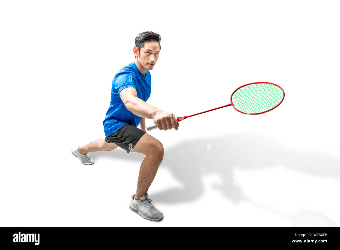 Asian man playing badminton isolated over white background Stock Photo