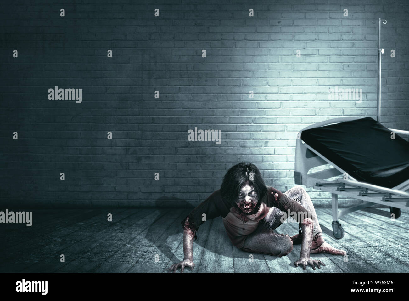Scary zombies with blood and wound on his body crawling on the abandoned hospital. Halloween concept Stock Photo