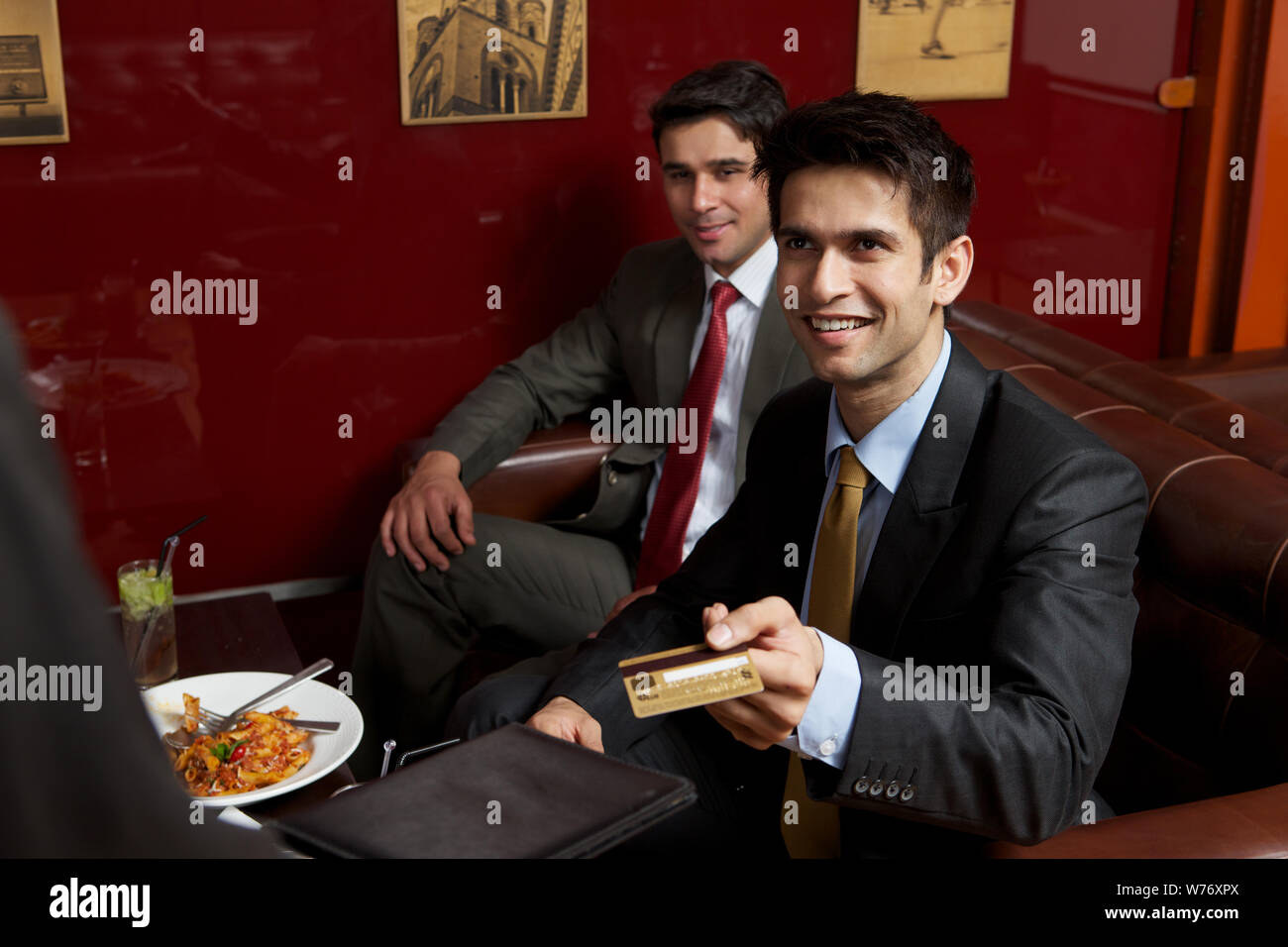 Business executives paying bill by credit card in a restaurant Stock Photo