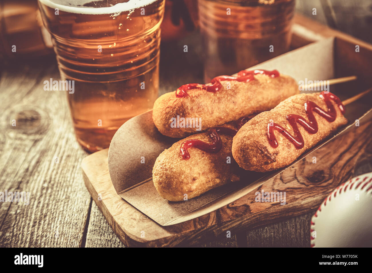 Corn dogs and beer on rustic background Stock Photo Alamy