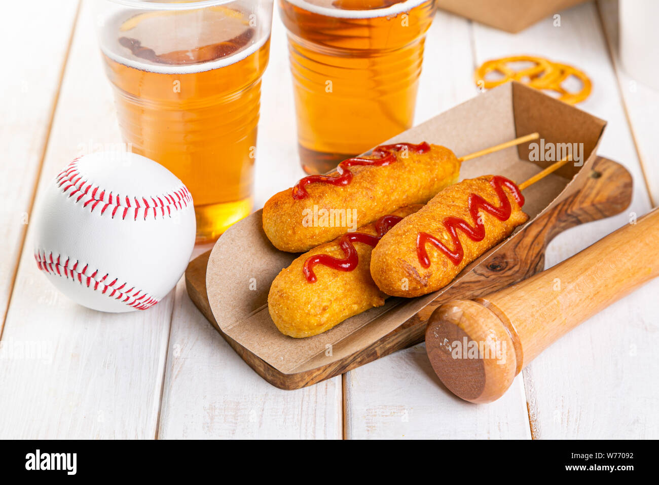 Corn dogs and beer on rustic background Stock Photo