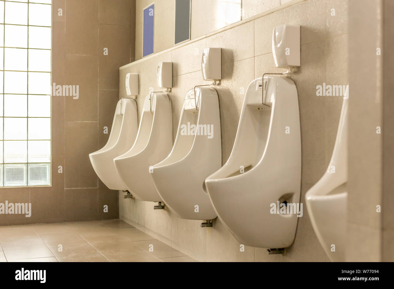 White urinals in a row in men public toilet Stock Photo Alamy