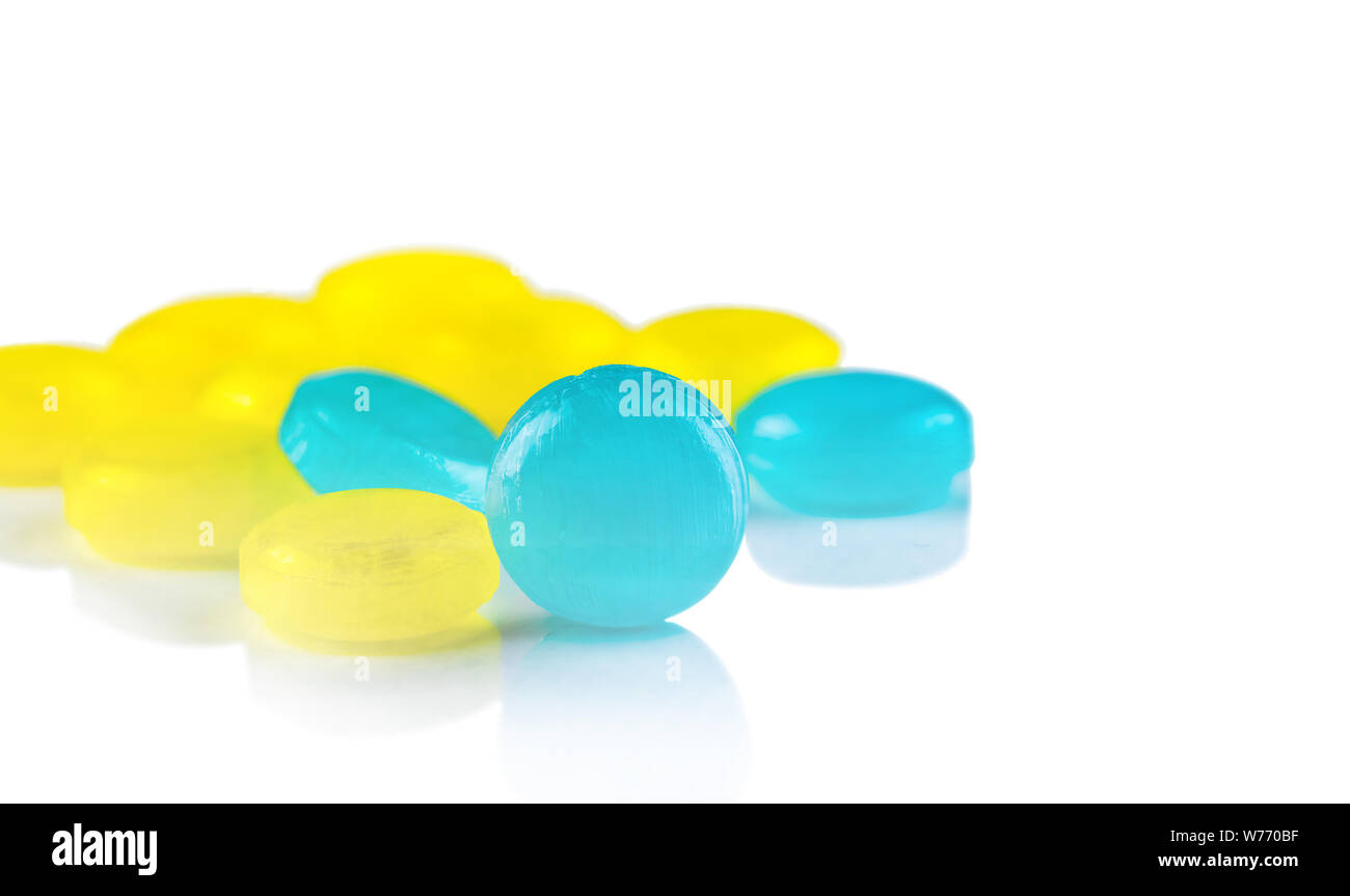Medical lozenges for relief cough, sore throat and throat irritation isolated on white background. Cough and colds drop. Colorful cough pastille. Blue Stock Photo