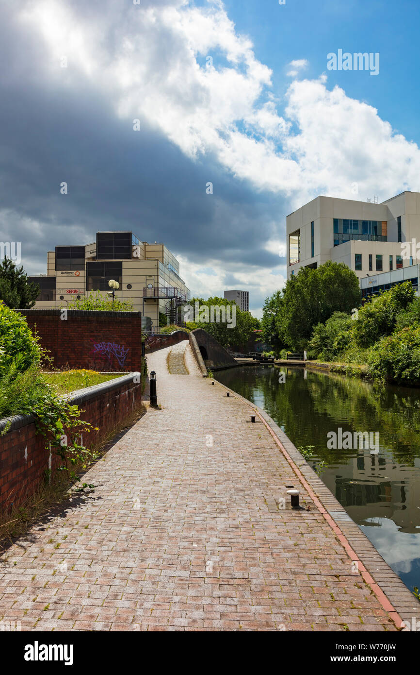 The Digbeth Branch Canal heads south into the city centre, the sunlight ...