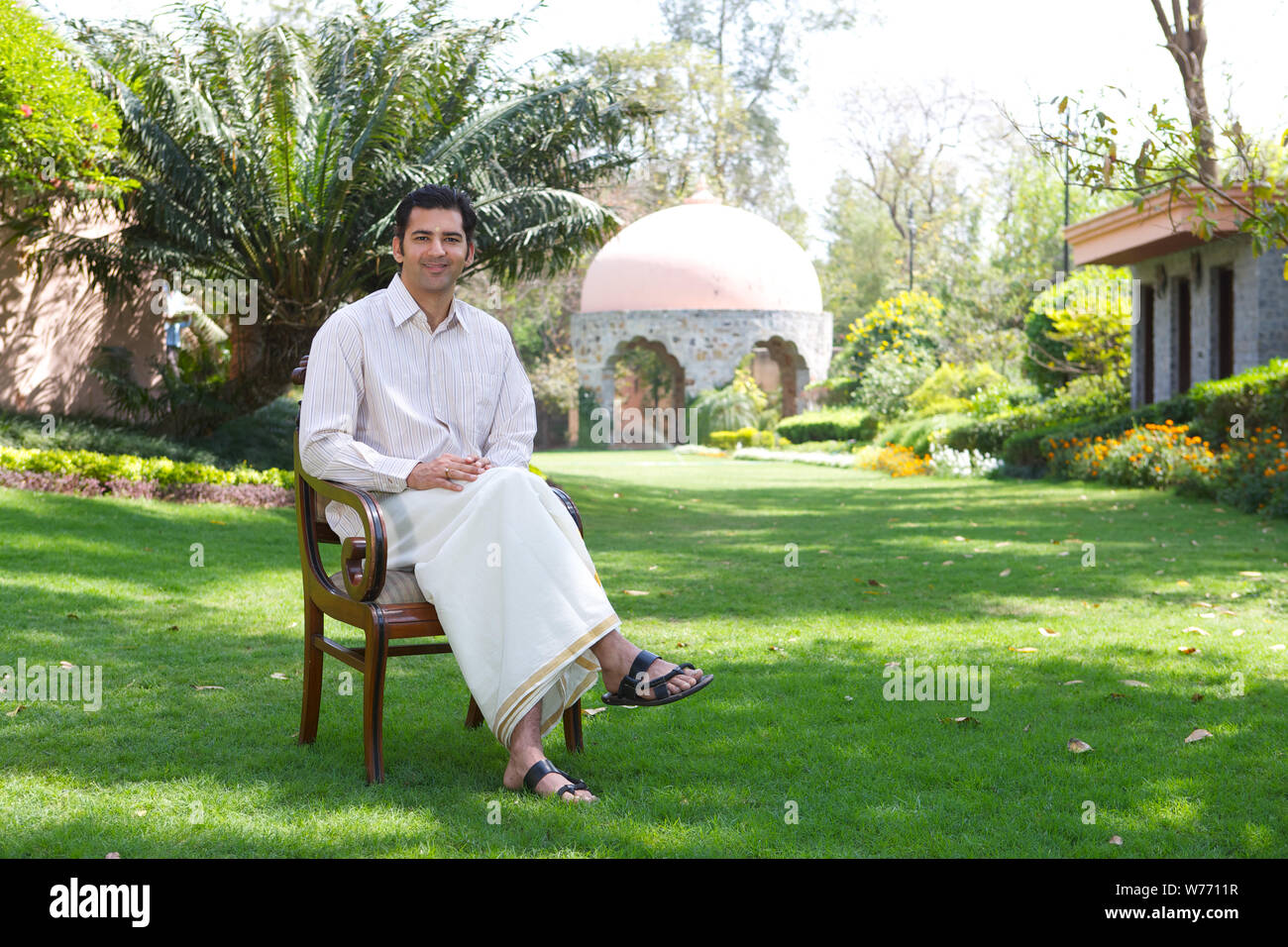 South Indian man sitting on a chair Stock Photo - Alamy